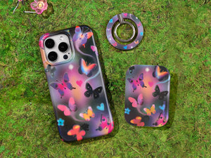 Tie-dye phone case with psychedelic rainbow swirl pattern on grass background