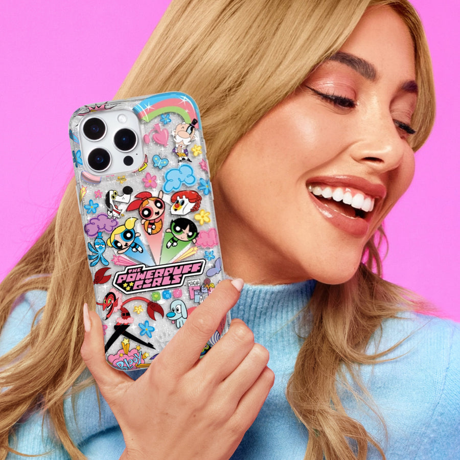 Powerpuff Girls phone case featuring Blossom, Bubbles, and Buttercup characters with colorful cartoon stickers and rainbow design, modeled by blonde woman in blue sweater